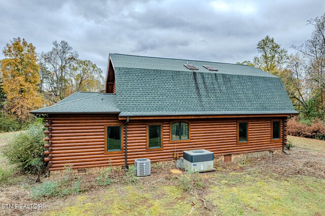 rear view of property featuring central AC