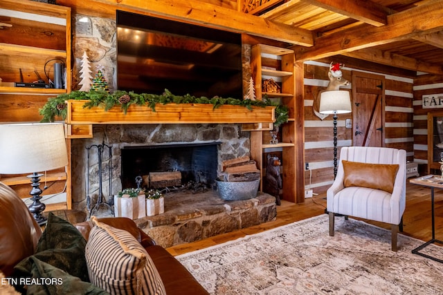 living room with wooden ceiling, wooden walls, hardwood / wood-style flooring, a fireplace, and beam ceiling