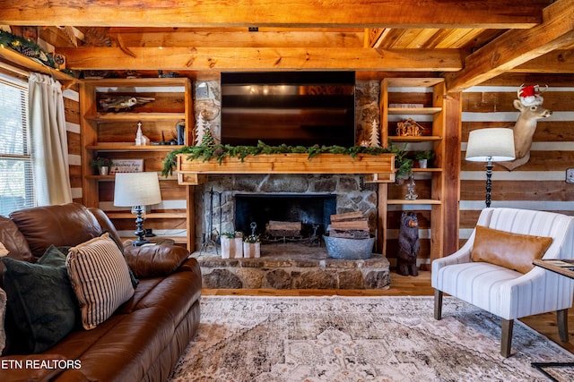 living room with beamed ceiling, wood-type flooring, a fireplace, and wooden ceiling