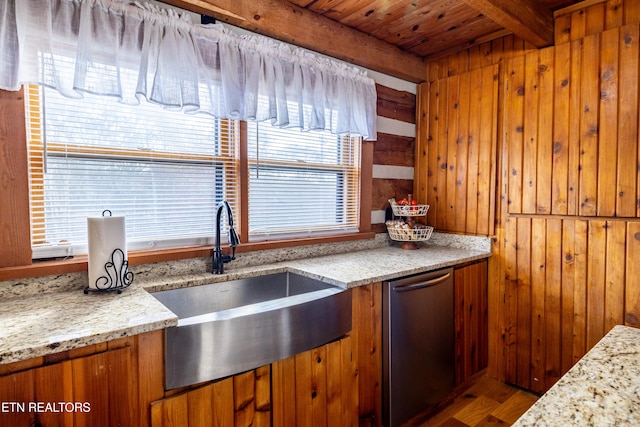 kitchen with beamed ceiling, light stone countertops, wooden ceiling, and wood walls