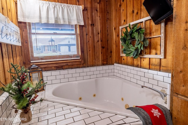 bathroom featuring wooden walls and a bathing tub