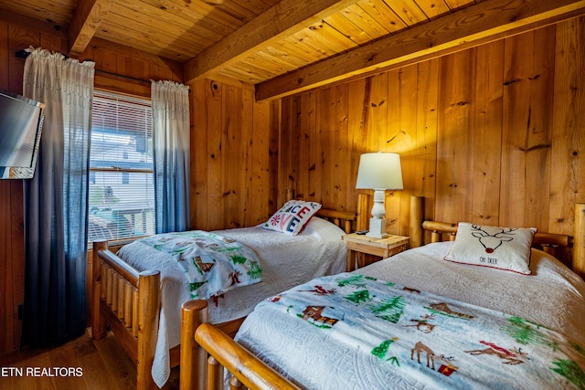 bedroom with wood walls, hardwood / wood-style floors, beamed ceiling, and wooden ceiling