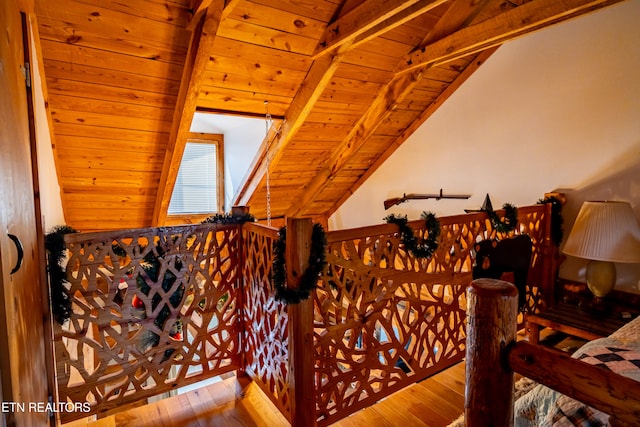 stairway featuring wood-type flooring, lofted ceiling with beams, and wood ceiling