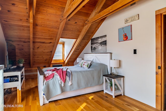 bedroom with hardwood / wood-style floors, vaulted ceiling with beams, and wood ceiling