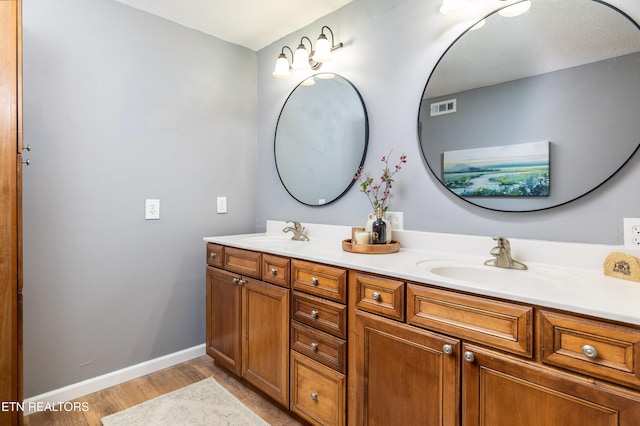 bathroom with vanity and hardwood / wood-style flooring