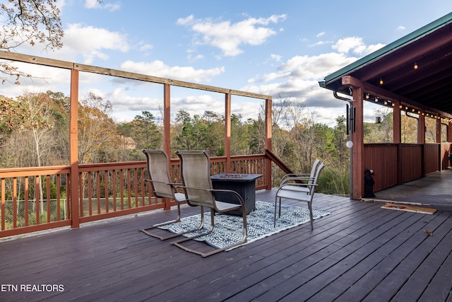 wooden deck featuring a fire pit