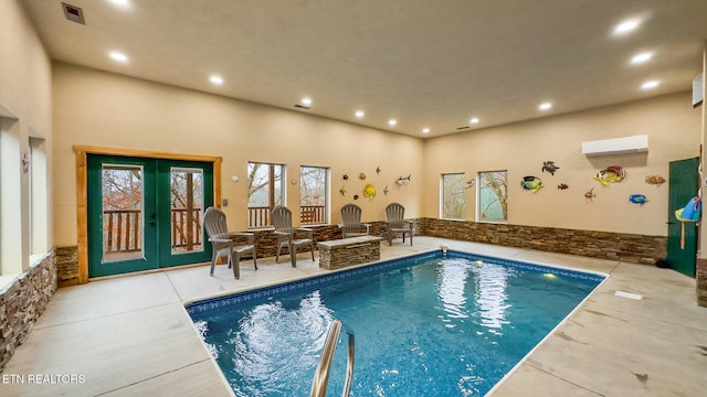 view of swimming pool featuring french doors and a wall mounted AC