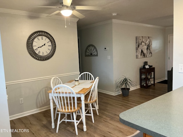 dining room with ceiling fan, dark hardwood / wood-style flooring, and crown molding