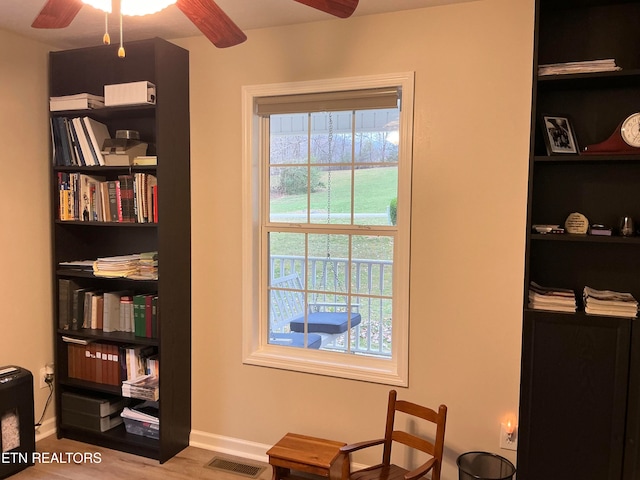 living area featuring ceiling fan and light wood-type flooring