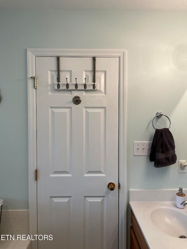 bathroom with tile patterned floors and vanity