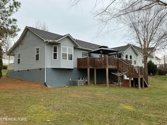 rear view of house featuring a lawn, a wooden deck, a gazebo, and central AC