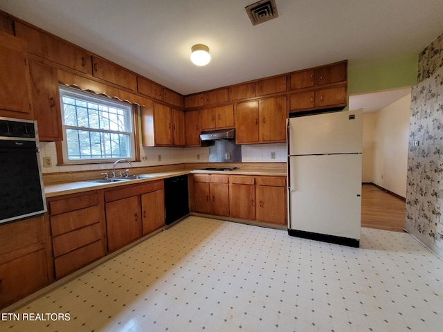 kitchen featuring sink and black appliances