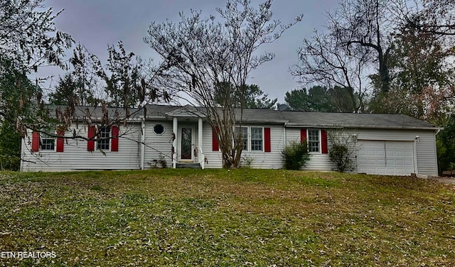 single story home with a garage and a yard