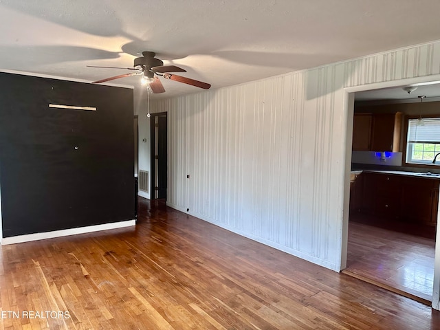 unfurnished room featuring hardwood / wood-style flooring and ceiling fan