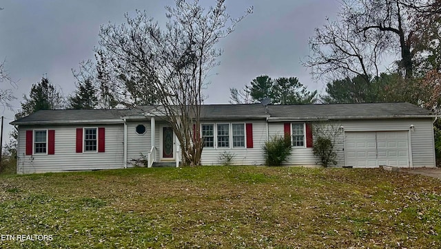 ranch-style home with a front lawn and a garage