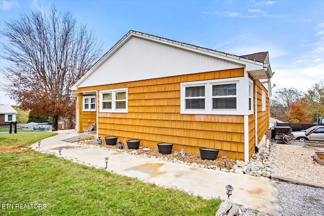 view of home's exterior with a lawn