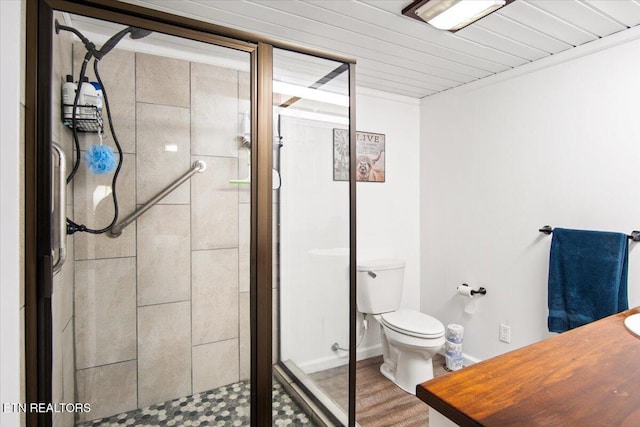 bathroom featuring hardwood / wood-style floors, toilet, and an enclosed shower