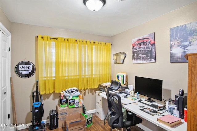 home office with hardwood / wood-style flooring