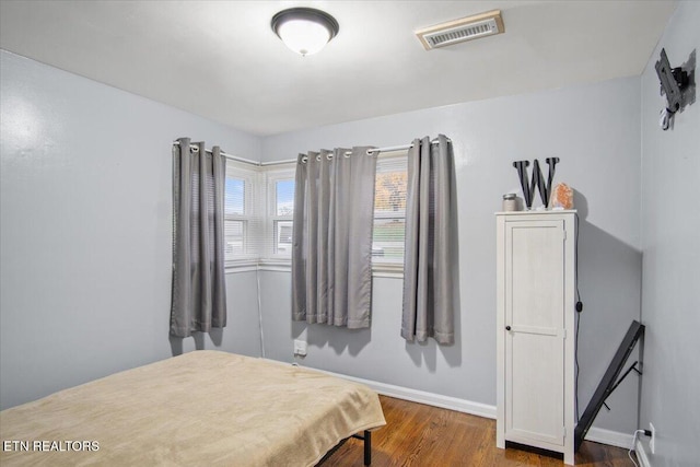 bedroom with hardwood / wood-style flooring