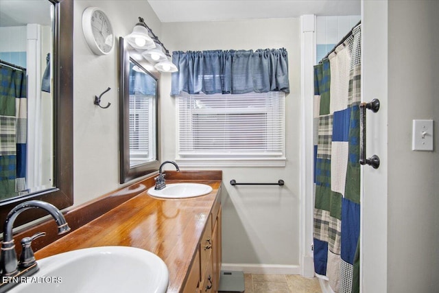 bathroom with a shower with shower curtain, vanity, and tile patterned floors