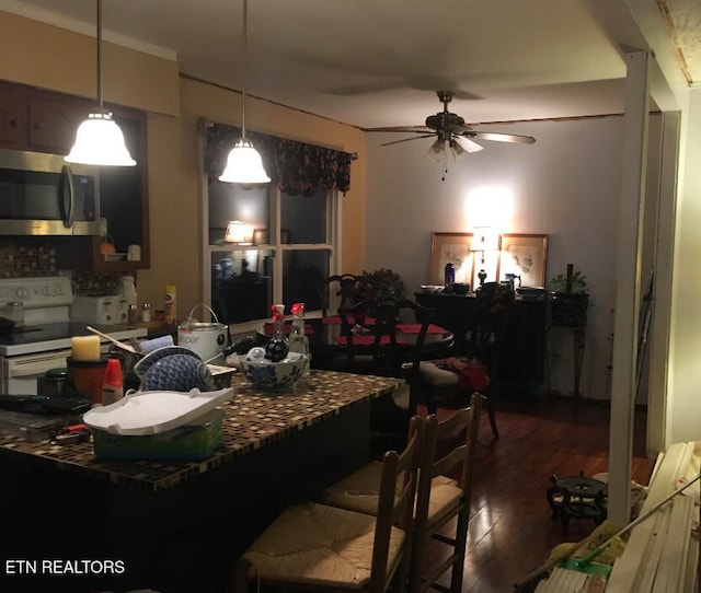 dining area with ceiling fan and dark wood-type flooring