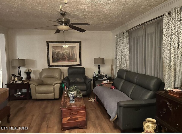 living room with ornamental molding, a textured ceiling, a ceiling fan, and wood finished floors