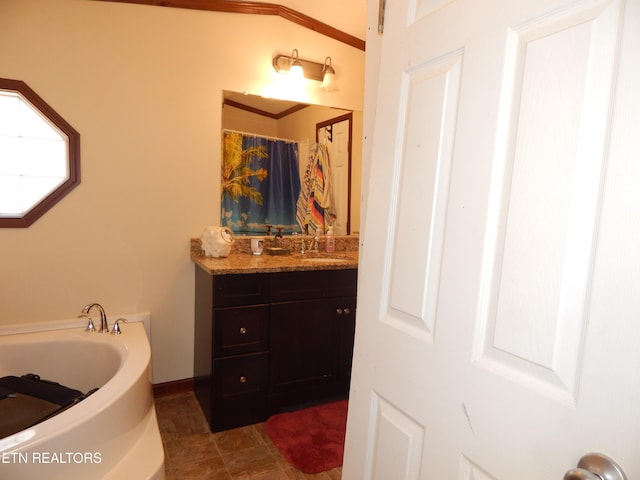 bathroom featuring crown molding, a washtub, and vanity