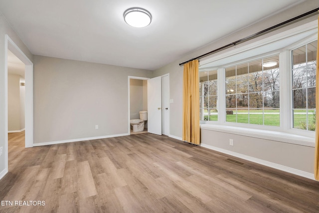 spare room with light hardwood / wood-style floors