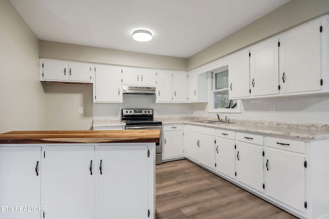 kitchen featuring stainless steel range with electric stovetop, white cabinets, and sink