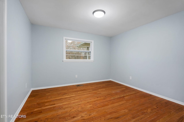 spare room with hardwood / wood-style floors