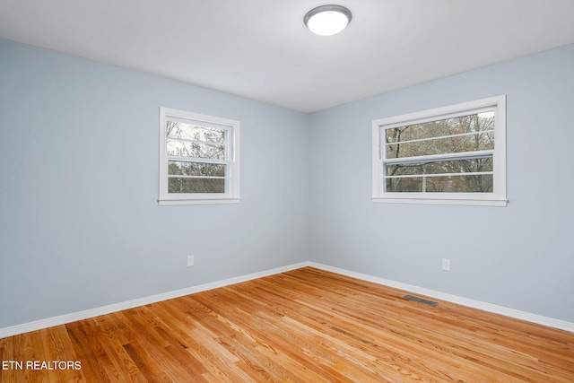 unfurnished room with light wood-type flooring