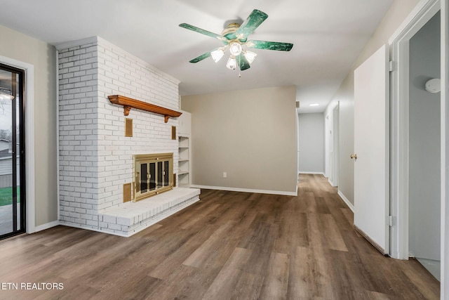 unfurnished living room with ceiling fan, a fireplace, and dark hardwood / wood-style floors