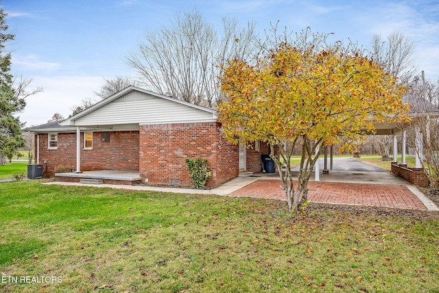 rear view of house featuring a patio, cooling unit, and a lawn