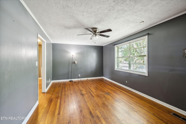 unfurnished room with ceiling fan, ornamental molding, a textured ceiling, and hardwood / wood-style flooring