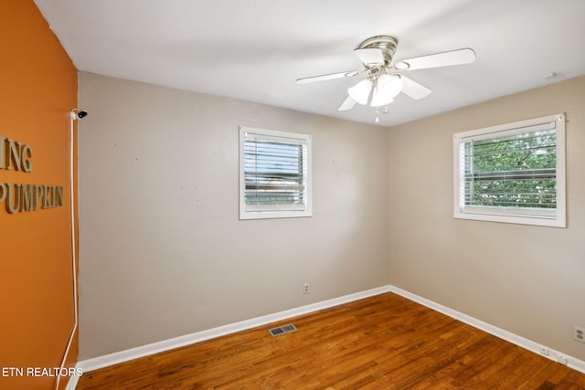 empty room featuring hardwood / wood-style flooring and ceiling fan