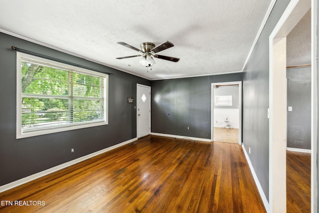 empty room featuring crown molding, ceiling fan, dark hardwood / wood-style flooring, and a textured ceiling