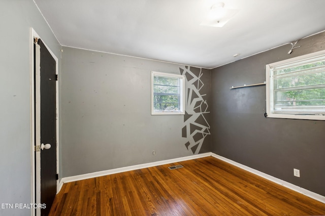 spare room with hardwood / wood-style flooring