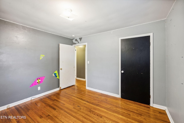 unfurnished bedroom featuring wood-type flooring