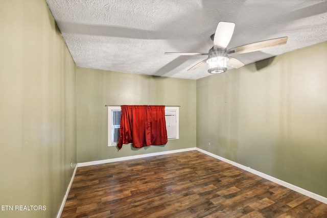 empty room with a textured ceiling, ceiling fan, and dark wood-type flooring