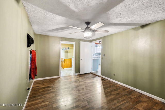 unfurnished bedroom featuring a textured ceiling, ceiling fan, and dark wood-type flooring