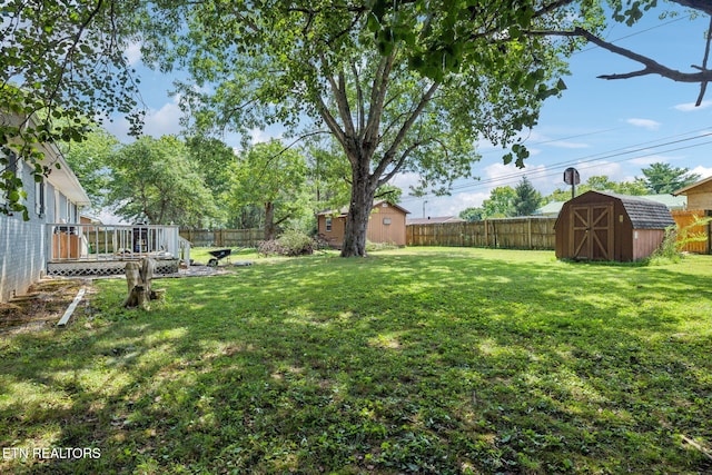 view of yard with a shed and a wooden deck