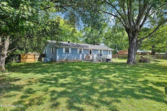 back of house with a yard and a deck