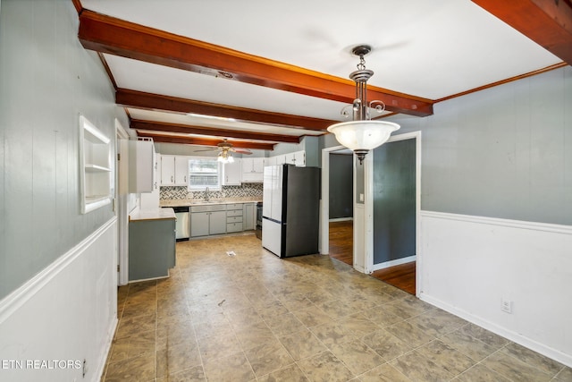 kitchen featuring white cabinetry, stainless steel appliances, beamed ceiling, decorative light fixtures, and decorative backsplash