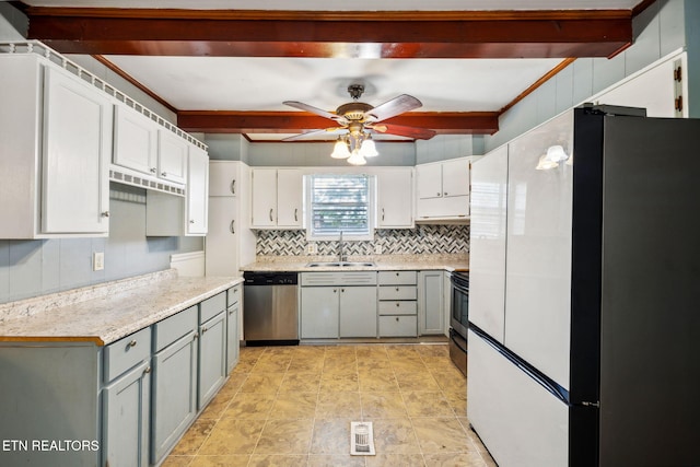 kitchen with dishwasher, white fridge, beamed ceiling, and sink