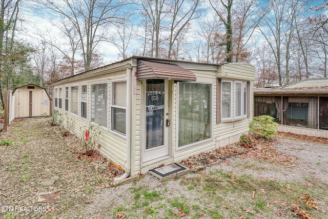 view of side of home with a storage unit