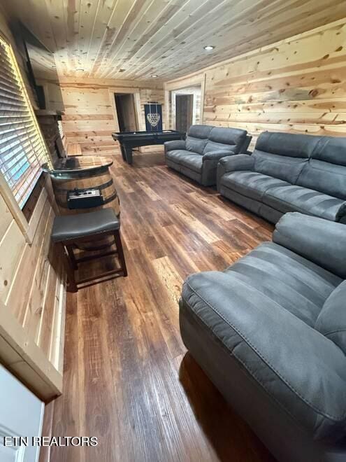 living room with wood walls, wood-type flooring, and wooden ceiling