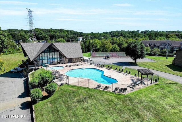 view of pool featuring a patio and a lawn