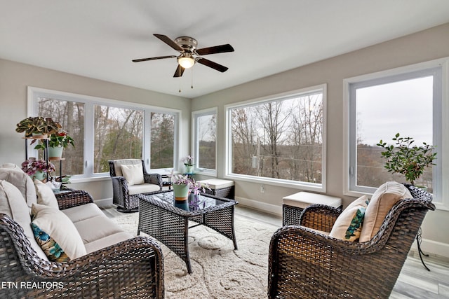 sunroom / solarium featuring ceiling fan