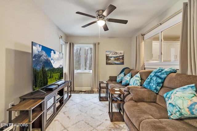 living room featuring ceiling fan and light wood-type flooring