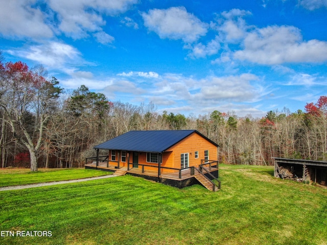 view of side of property with a lawn and a porch